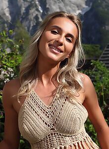 Gorgeous blonde spreading nude in a field