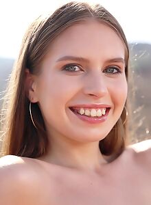 Cute girl with puffy nipples nude on a montain