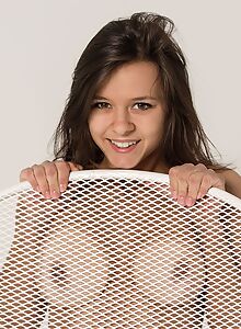 Cute brunette pulls her thong aside on a chair