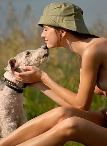 Skinny brunette posing naked with her dog