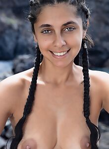 Shaved exotic girl with dark nipples nude by the sea