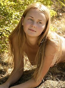 Cute shaved blonde posing nude outdoors