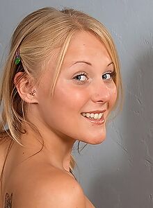 Flat-chested blonde teen spreading her shaved pussy