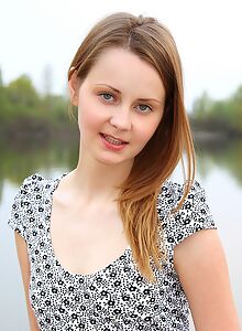 Lovely shaved girl lifts up her dress by the bay