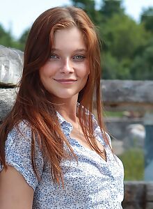 Cute freckled redhead stripping in a cabin