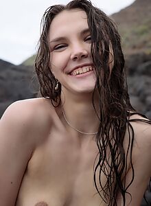 Skinny brunette takes off her bikini by the sea