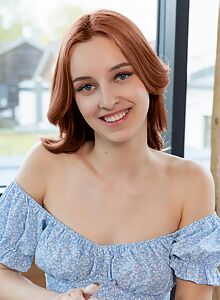 Cute shaved redhead takes off her skirt