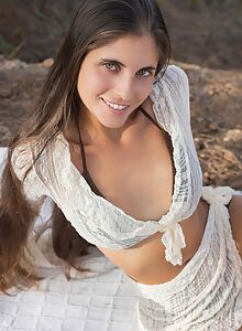 Long-haired brunette with tan lines takes off her bikini outdoors