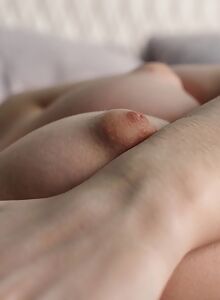 Cute shaved brunette with puffy nipples spreading in bed