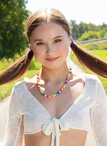 Cute brunette with long hair naked on her scooter