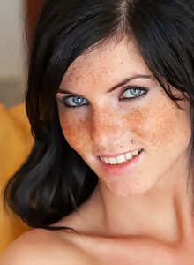 Freckled babe with black hair in black lingerie