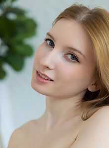 Shaved blonde with fair skin lifts up her dress