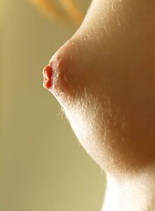 Cute brunette with puffy nipples stripping on the couch