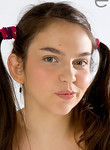 Brunette teen with pigtails sucking a lollipop