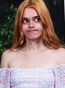 Cute redhead lifts up her dress and spreads her ass