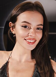 Shaved brunette masturbating in a skimpy dress