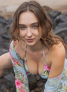 Beautiful busty girl takes off her bikini at the beach