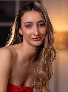 Blue-eyed blonde girl lifts up her dress on the couch