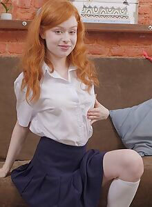 Shaved redhead schoolgirl toying on the couch