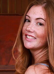Freckled redhead spreads her asshole