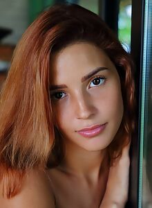 Redhead Latina exposes her round ass on a terrace