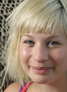 Freckled blonde with blue eyes stripping