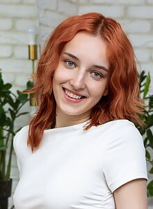 Cute redhead exposes her shaved pussy