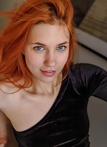 Cute redhead with blue eyes spreading in stockings