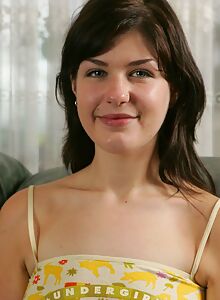 Cute brunette amateur spreads her hairy pussy on the couch