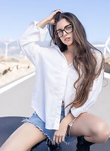 Shaved brunette with firm tits spreading on a road