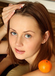 Gorgeous naked teen playing with oranges