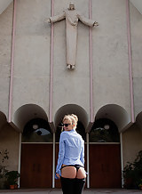 Non-nude busty blonde shows off her ass in front of a church