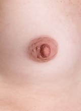 Freckled redhead with small tits stripping