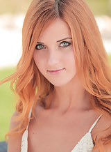 Tanned redhead posing nude