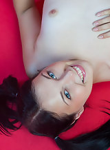 Blue-eyed black-haired teen spreads her legs