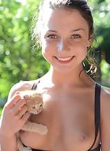 Freckled brunette teen having fun with kittens