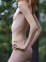 Skinny redhead with pale skin nude in a forest