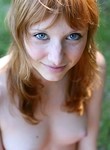 Freckled redhead teen posing naked by the woods
