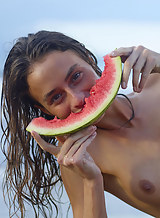 Skinny model Cleo eating watermelon on a nude beach