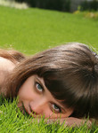 Cute brunette teen naked in the grass