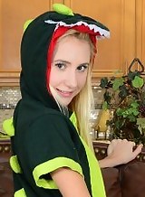 Petite blonde dressed as a dragon licks her own feet