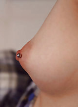 Tattooed brunette amateur shows off her pierced nipples