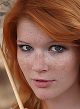 Freckled redhead Mia Sollis nude by a tree