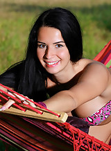 Black-haired hottie with tan lines nude in a hammock