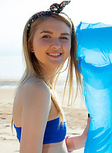 Flat-chested blonde teen spreading at the beach