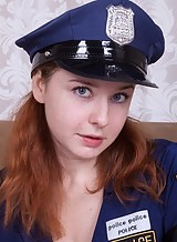 Chubby redhead with big tits in a police uniform spreading her hairy pussy